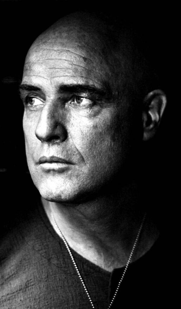 This black and white image features Marlon Brando as Colonel Kurtz the antagonist in the movie.  
